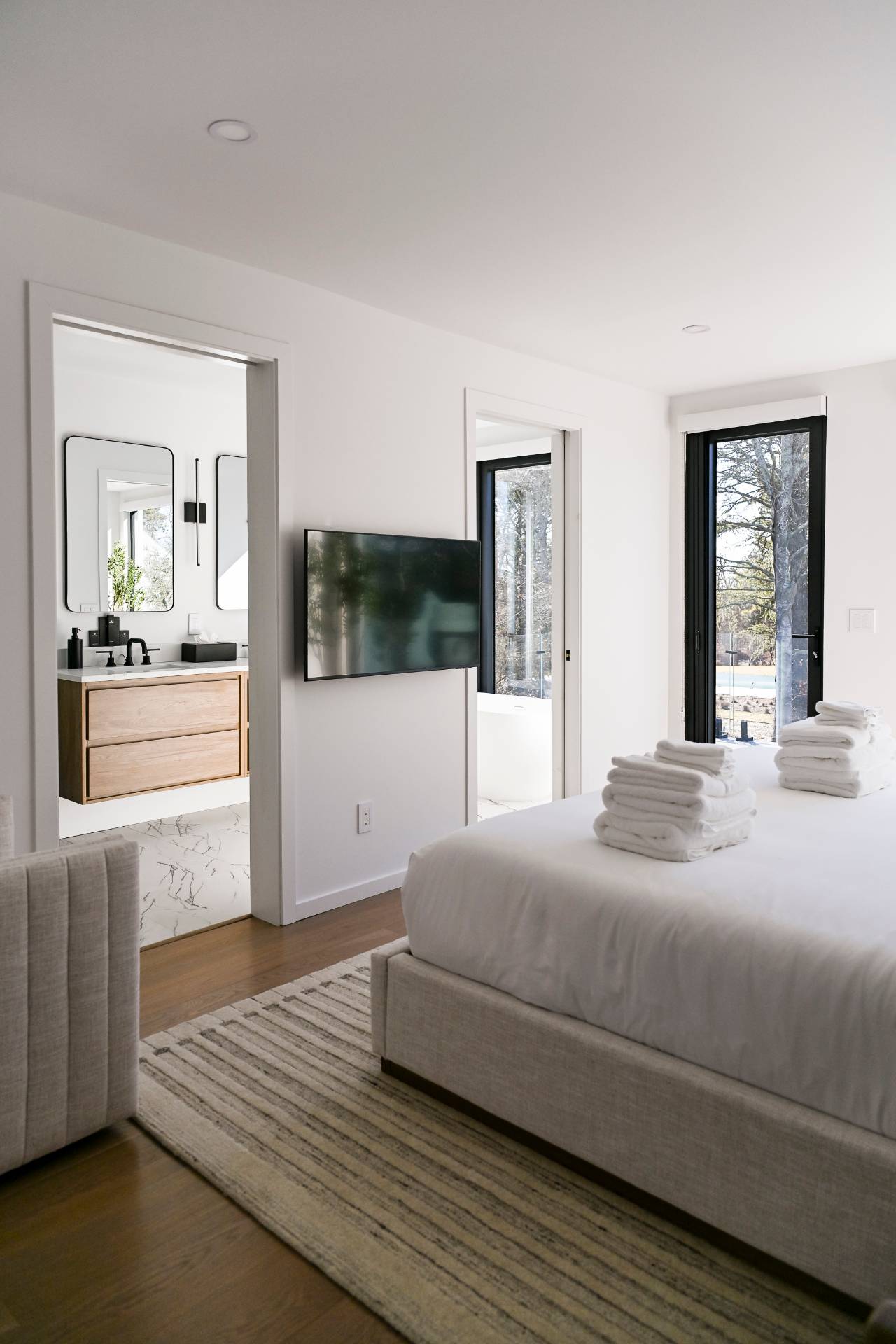 5 Ridge Lane Hampton Bays, NY 11946 - Photo 36 of 38 a bedroom with a bed and a large window