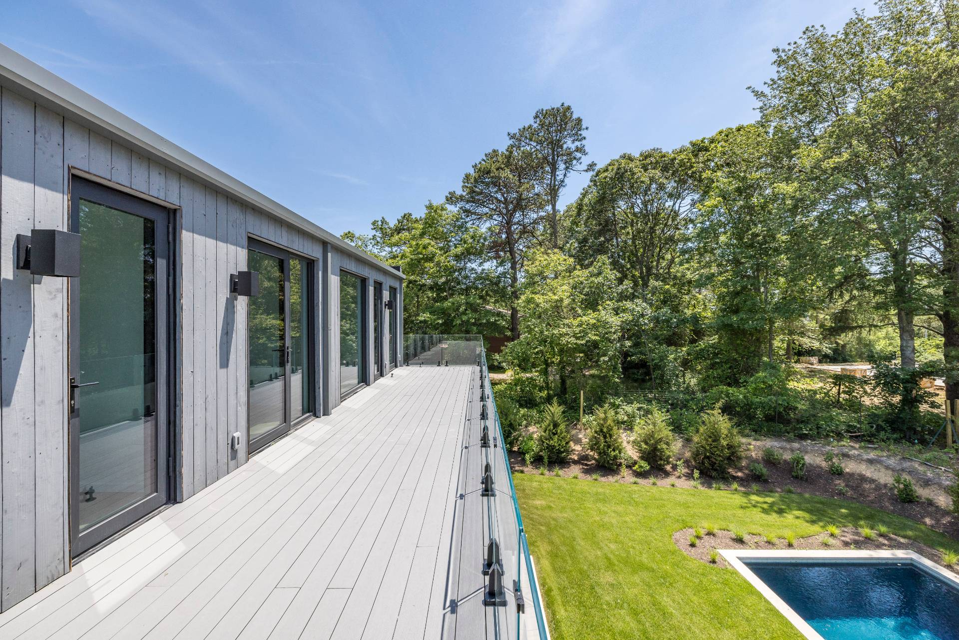 5 Ridge Lane Hampton Bays, NY 11946 - Photo 4 of 38 a view of backyard with swimming pool and outdoor seating