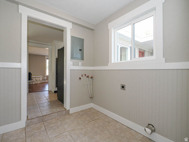 154 East 3000th Street South Bountiful, UT 84010 - Photo 28 of 37 Utility room featuring tile flooring, wainscoting, a double-pane window, and a finished doorway
