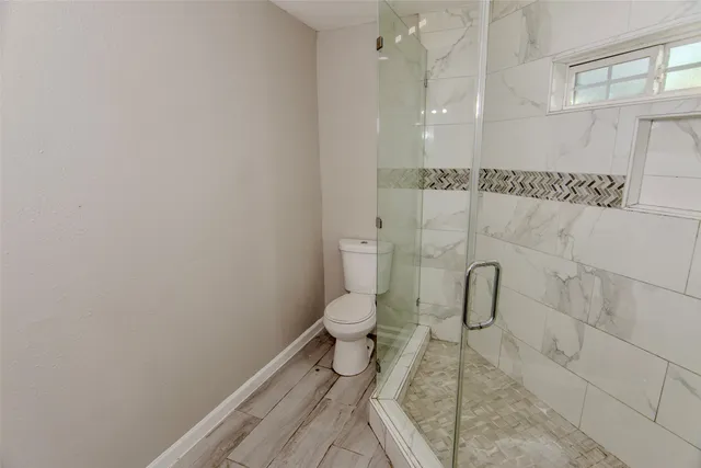 a bathroom with a toilet and a shower