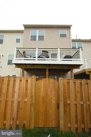 a kitchen with a wooden floor and more windows