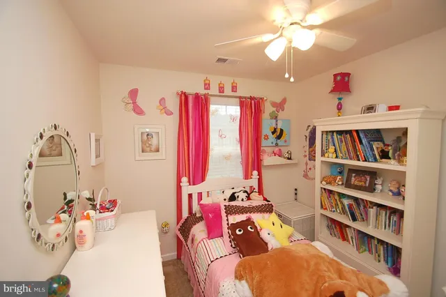 a bedroom with furniture and a book shelf
