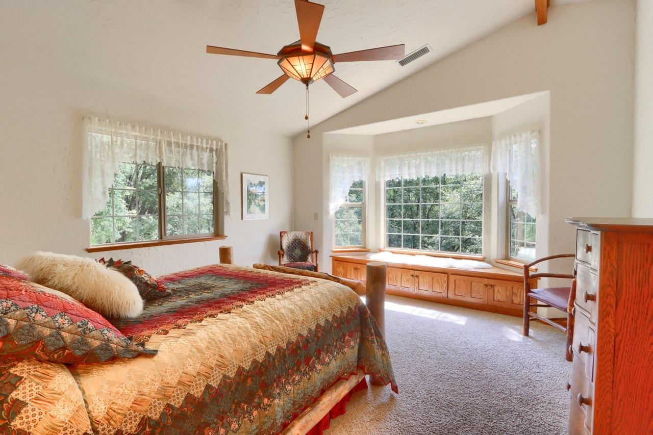 2403 Parmabelle Road Mariposa, CA 95338 - Photo 20 of 26 a bed sitting in a bedroom next to a window
