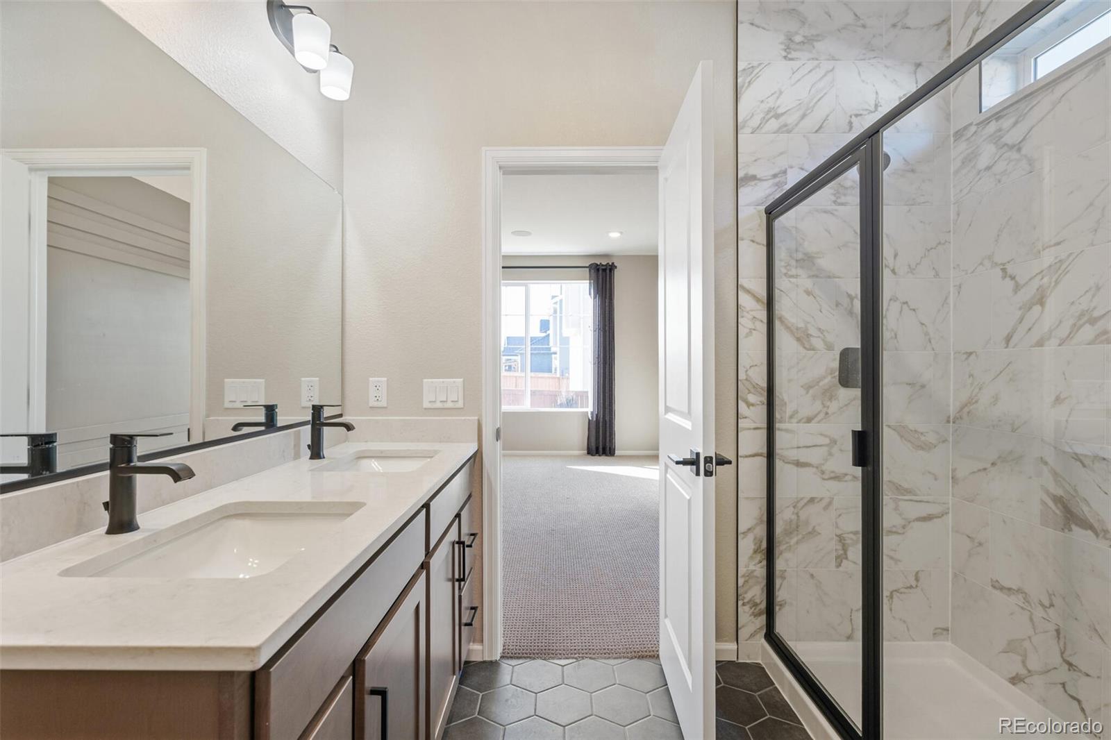 2155 Farmlore Drive Brighton, CO 80601 - Photo 27 of 41 a bathroom with a sink a vanity and a mirror
