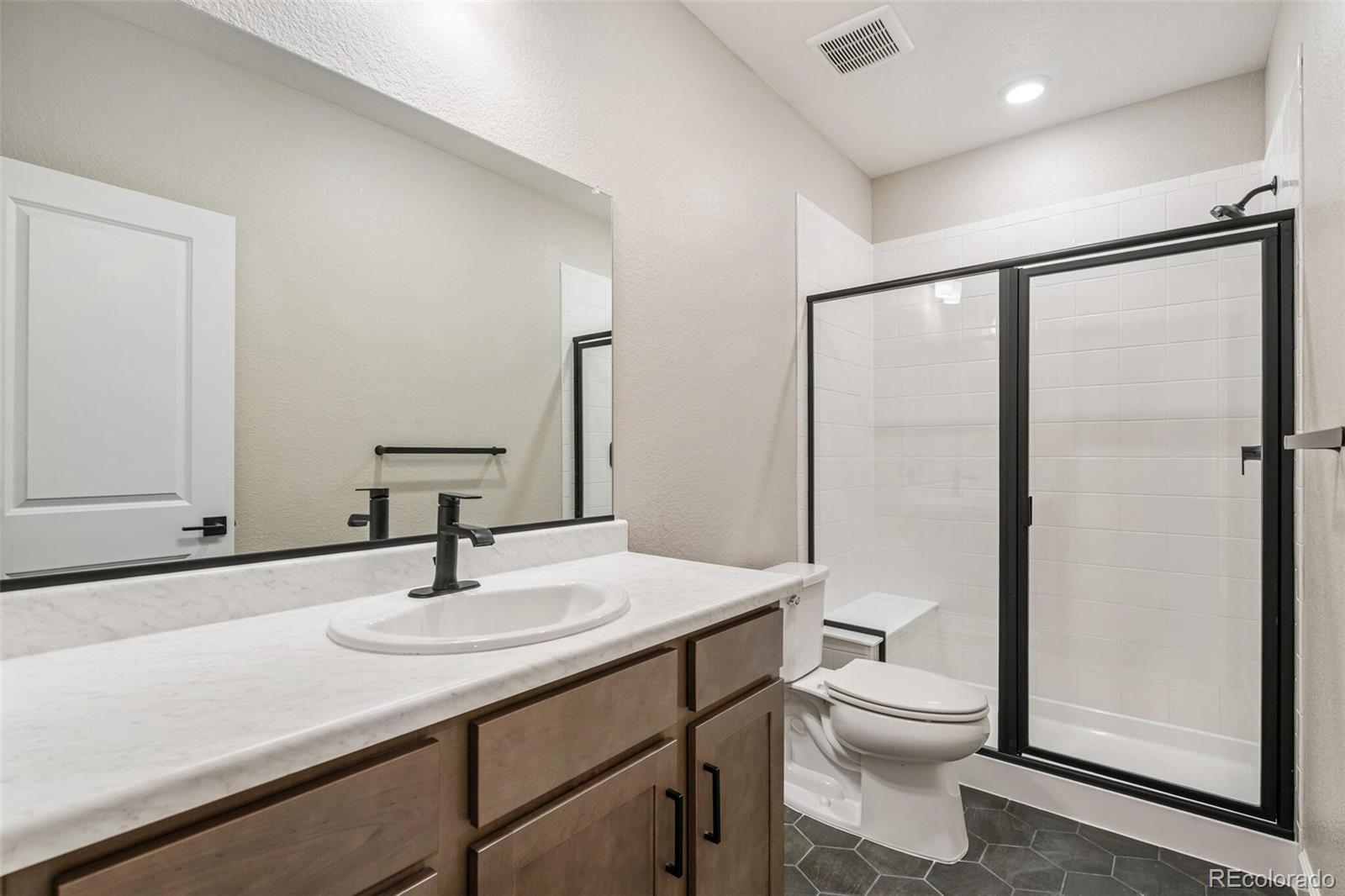 2155 Farmlore Drive Brighton, CO 80601 - Photo 36 of 41 a bathroom with a sink toilet and shower