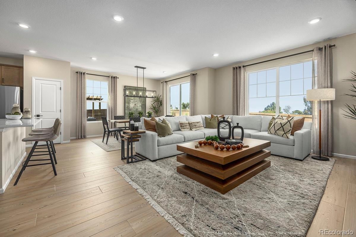 2155 Farmlore Drive Brighton, CO 80601 - Photo 4 of 41 a living room with furniture a rug and a table