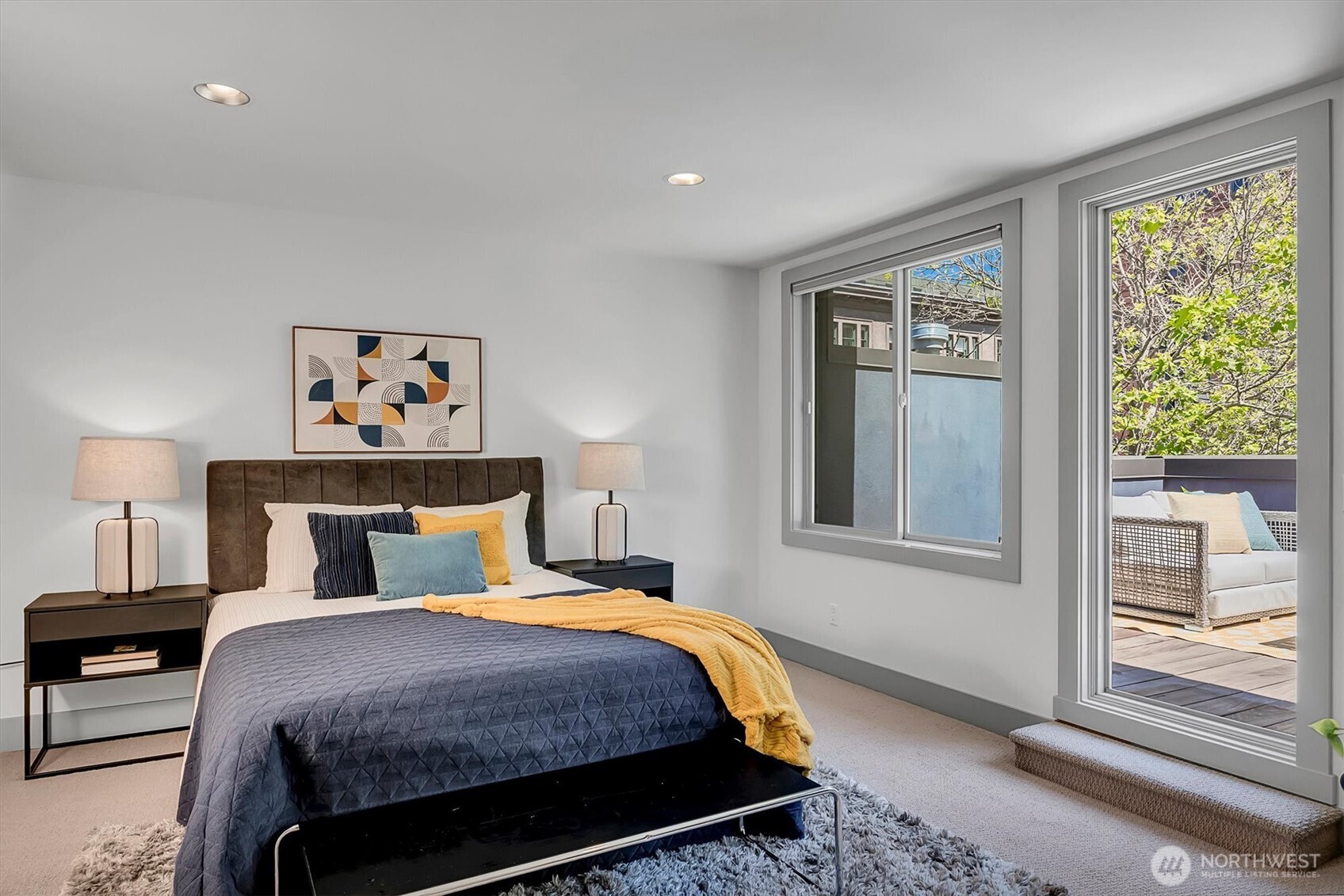 121 South Jackson Street, Unit 4 Seattle, WA 98104 - Photo 19 of 38 a bedroom with a bed a painting and a window