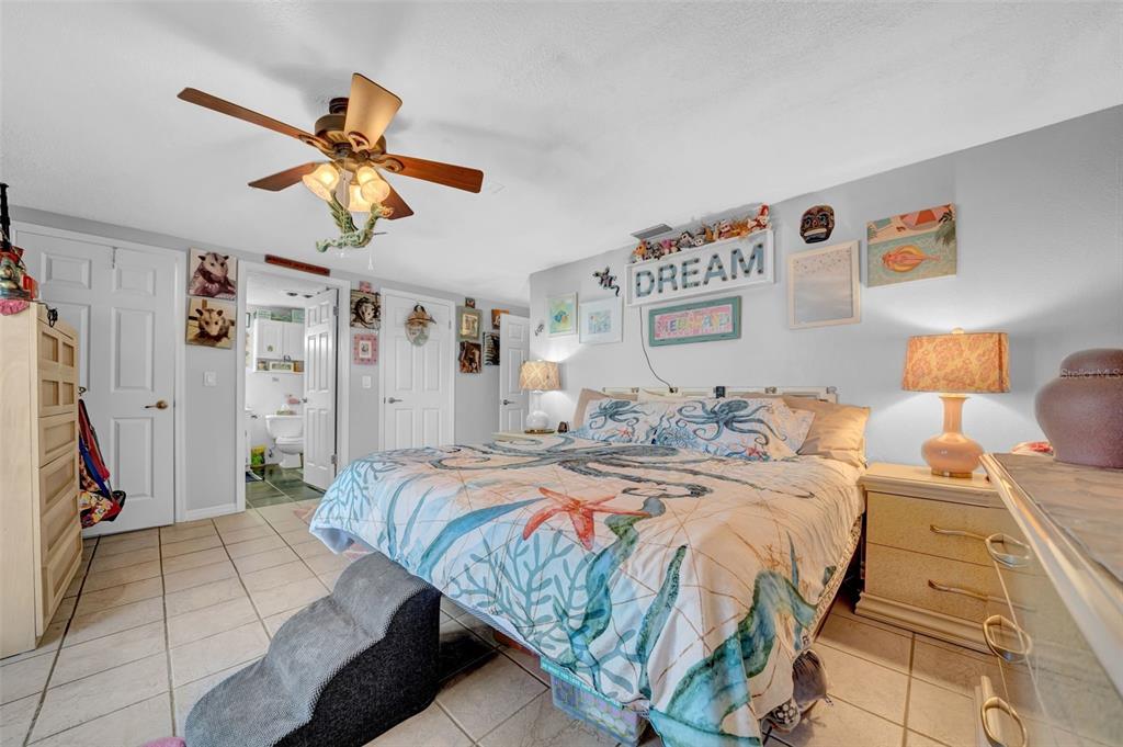 7353 Banner Street New Port Richey, FL 34653 - Photo 19 of 49 a bedroom with a bed ceiling fan and a dresser