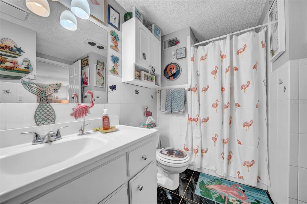 7353 Banner Street New Port Richey, FL 34653 - Photo 22 of 49 a bathroom with a sink toilet and shower curtain
