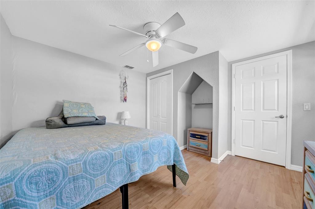 7353 Banner Street New Port Richey, FL 34653 - Photo 29 of 49 a bedroom with a bed and a chandelier