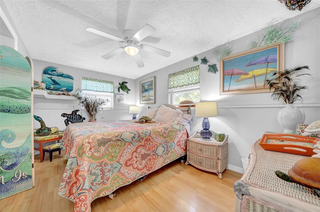 7353 Banner Street New Port Richey, FL 34653 - Photo 32 of 49 a bedroom with a bed and a chandelier