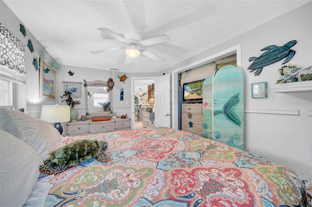 7353 Banner Street New Port Richey, FL 34653 - Photo 33 of 49 a bedroom with a bed and a chandelier