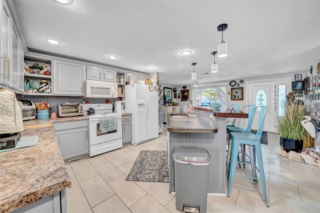 7353 Banner Street New Port Richey, FL 34653 - Photo 10 of 49 a kitchen with white cabinets and refrigerator