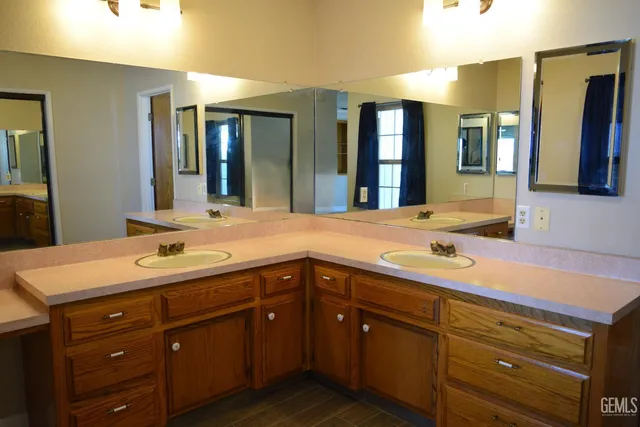 a bathroom with a sink double vanity and a mirror