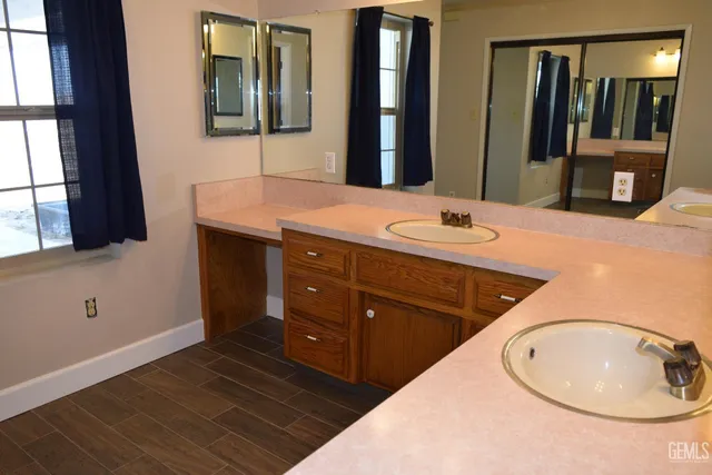 a bathroom with a double vanity sink and a mirror