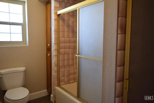 a bathroom with a toilet and shower