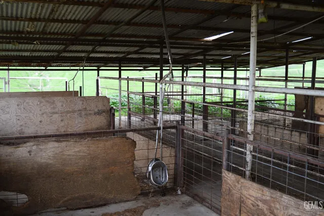 a view of room with stairs and wooden walls