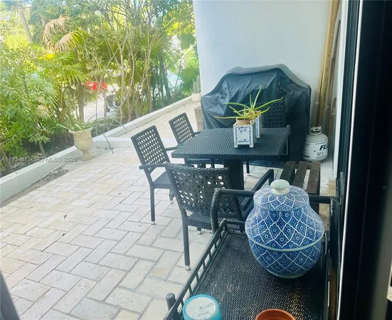 a view of outdoor dining space with a table and chairs