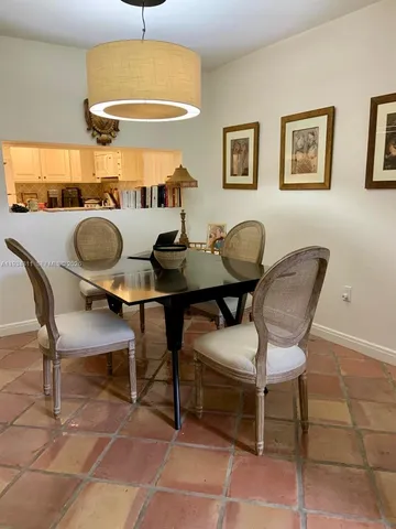 a view of a dining room with furniture and a chandelier