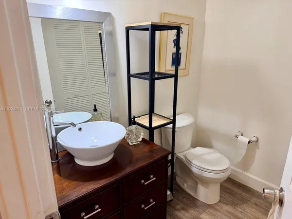 a bathroom with a sink toilet and mirror