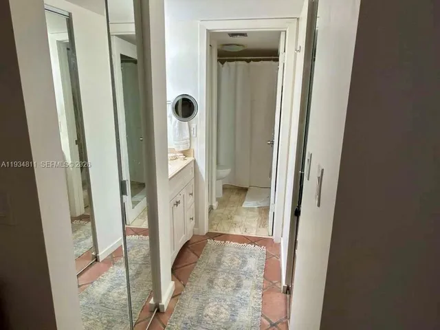 a view of a bathroom from a hallway