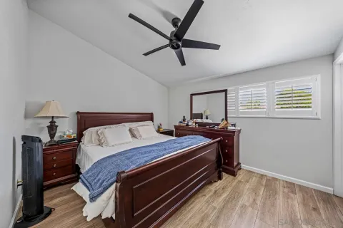 a bed room with a bed and a ceiling fan