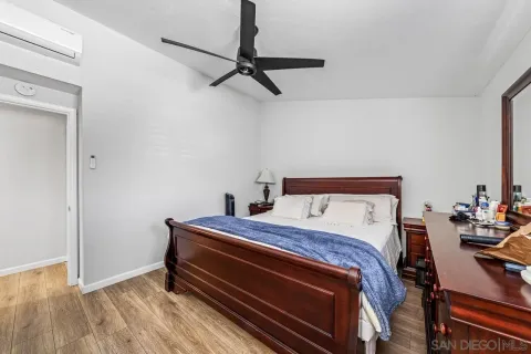 a bedroom with a bed and wooden floor