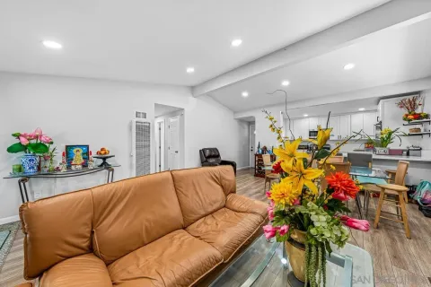 a living room with furniture flowers and a chandelier