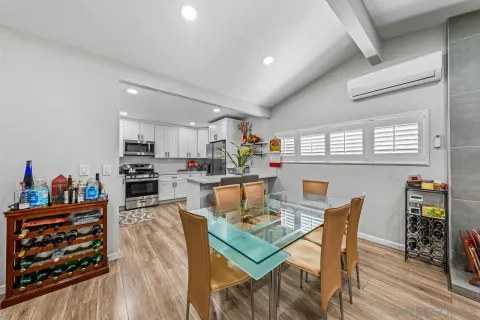 a dining room with furniture and wooden floor
