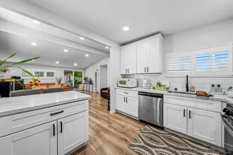 a kitchen with white cabinets and white appliances