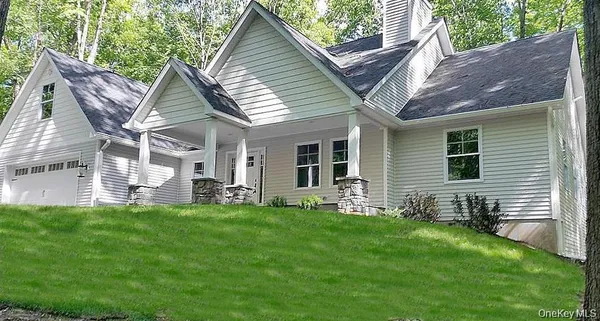 a view of a house with a yard and sitting area