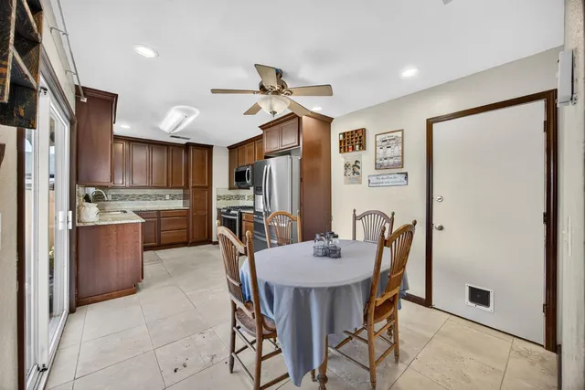 a view of a dining room with furniture and a chandelier