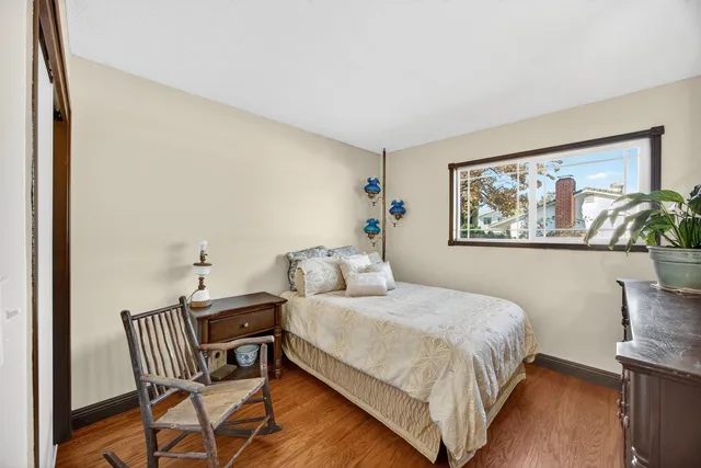 a bedroom with a bed and a painting on the wall