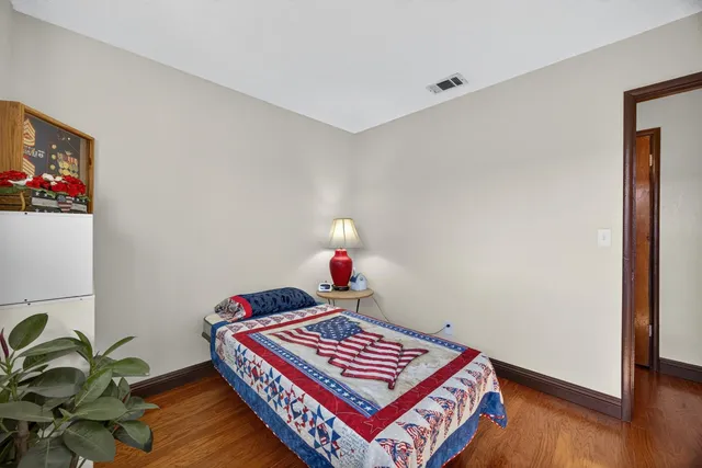 a living room with a piano and paintings on the wall