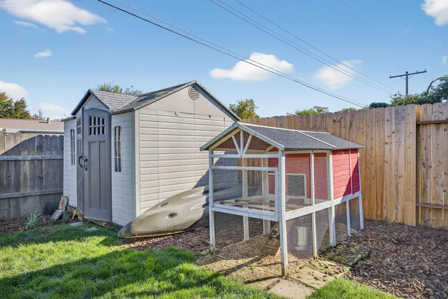 a view of a patio with table and chairs and potted plants