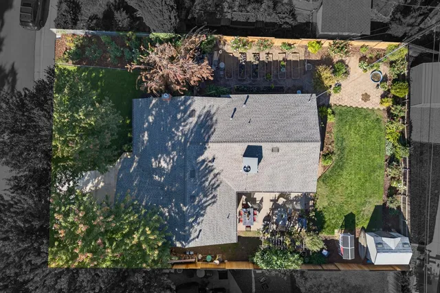 an aerial view of a house with a yard basket ball court and outdoor seating