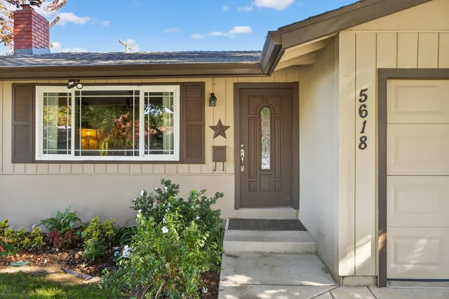 a front view of a house with a glass windows