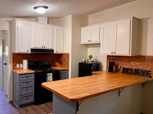 a kitchen with a stove and a refrigerator