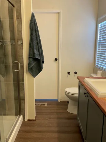 a bathroom with a toilet and a shower