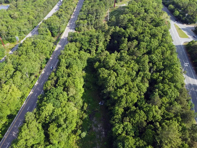a view of a field with trees in the background
