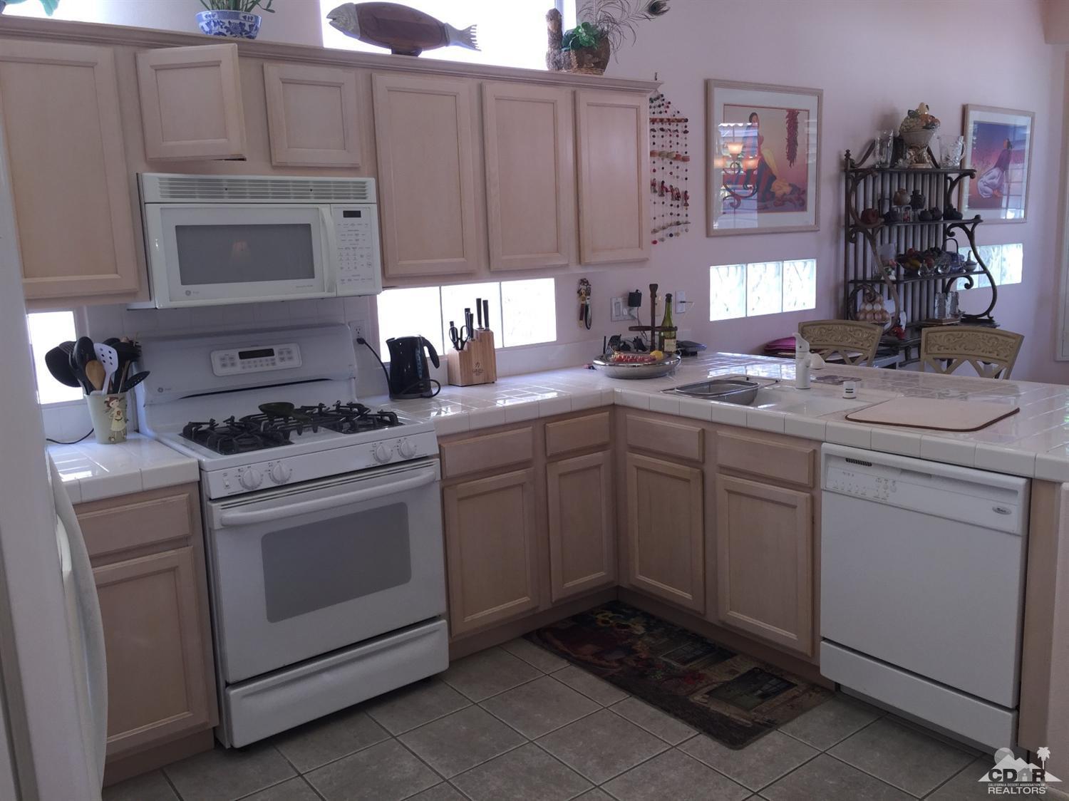 37339 Skycrest Road Palm Desert, CA 92211 - Photo 12 of 39 a kitchen with cabinets appliances a sink and a counter top space