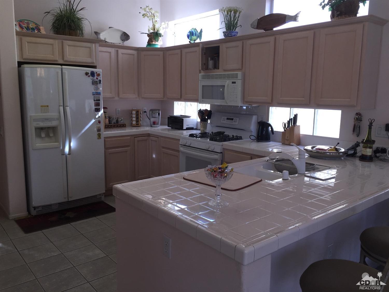 37339 Skycrest Road Palm Desert, CA 92211 - Photo 14 of 39 a kitchen with stainless steel appliances granite countertop a sink refrigerator and cabinets