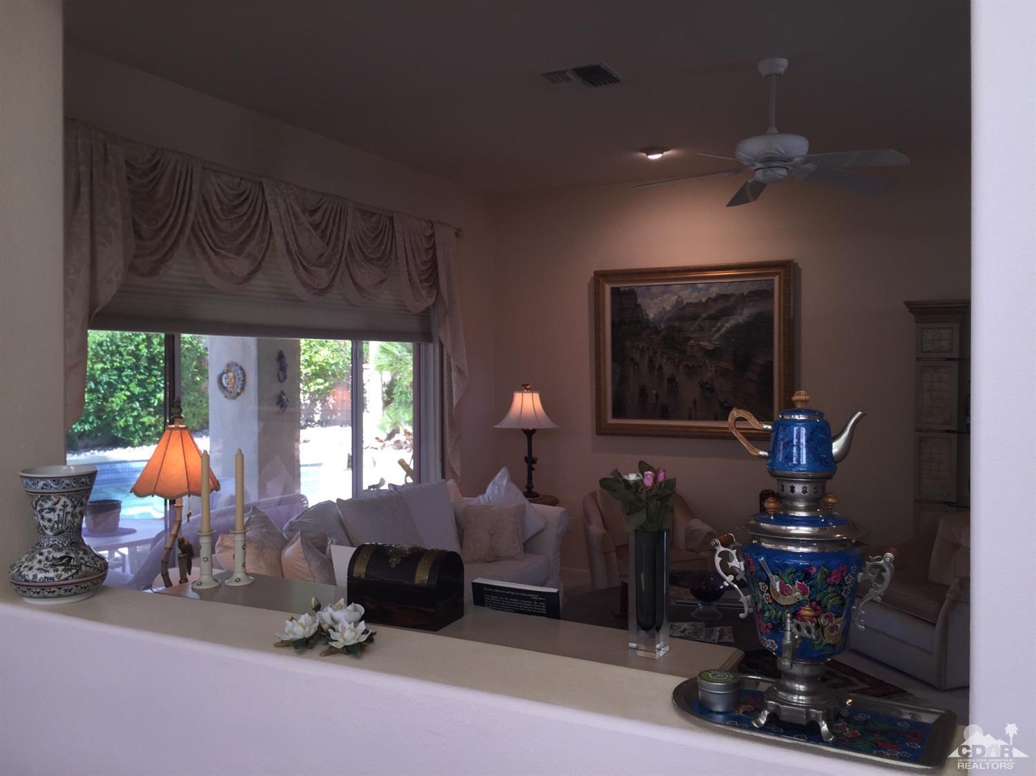 37339 Skycrest Road Palm Desert, CA 92211 - Photo 17 of 39 a living room with furniture a window and a chandelier