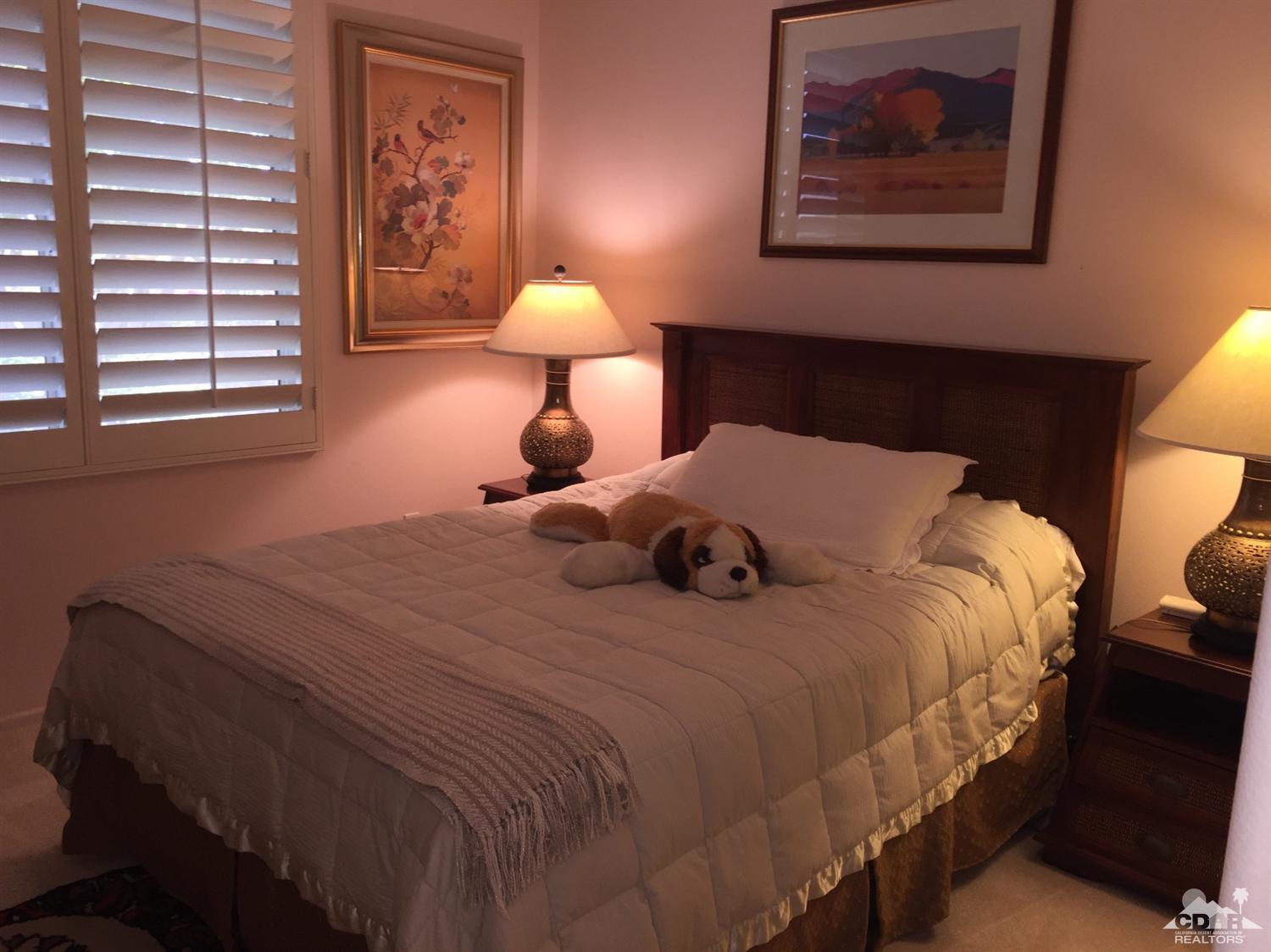 37339 Skycrest Road Palm Desert, CA 92211 - Photo 18 of 39 a bedroom with a bed and lamp with window