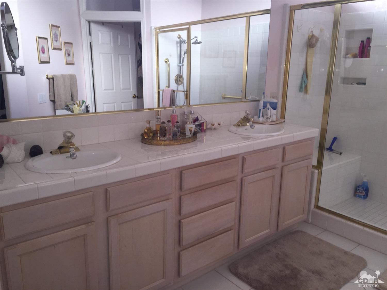 37339 Skycrest Road Palm Desert, CA 92211 - Photo 23 of 39 a bathroom with a double vanity sink and mirror