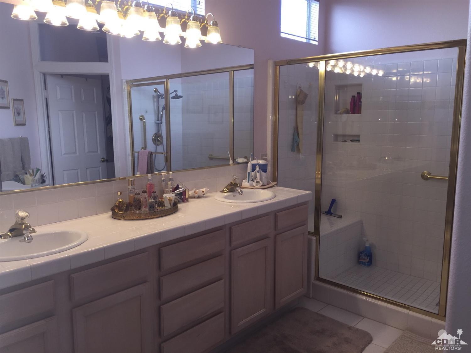 37339 Skycrest Road Palm Desert, CA 92211 - Photo 24 of 39 a bathroom with a double vanity sink mirror and shower