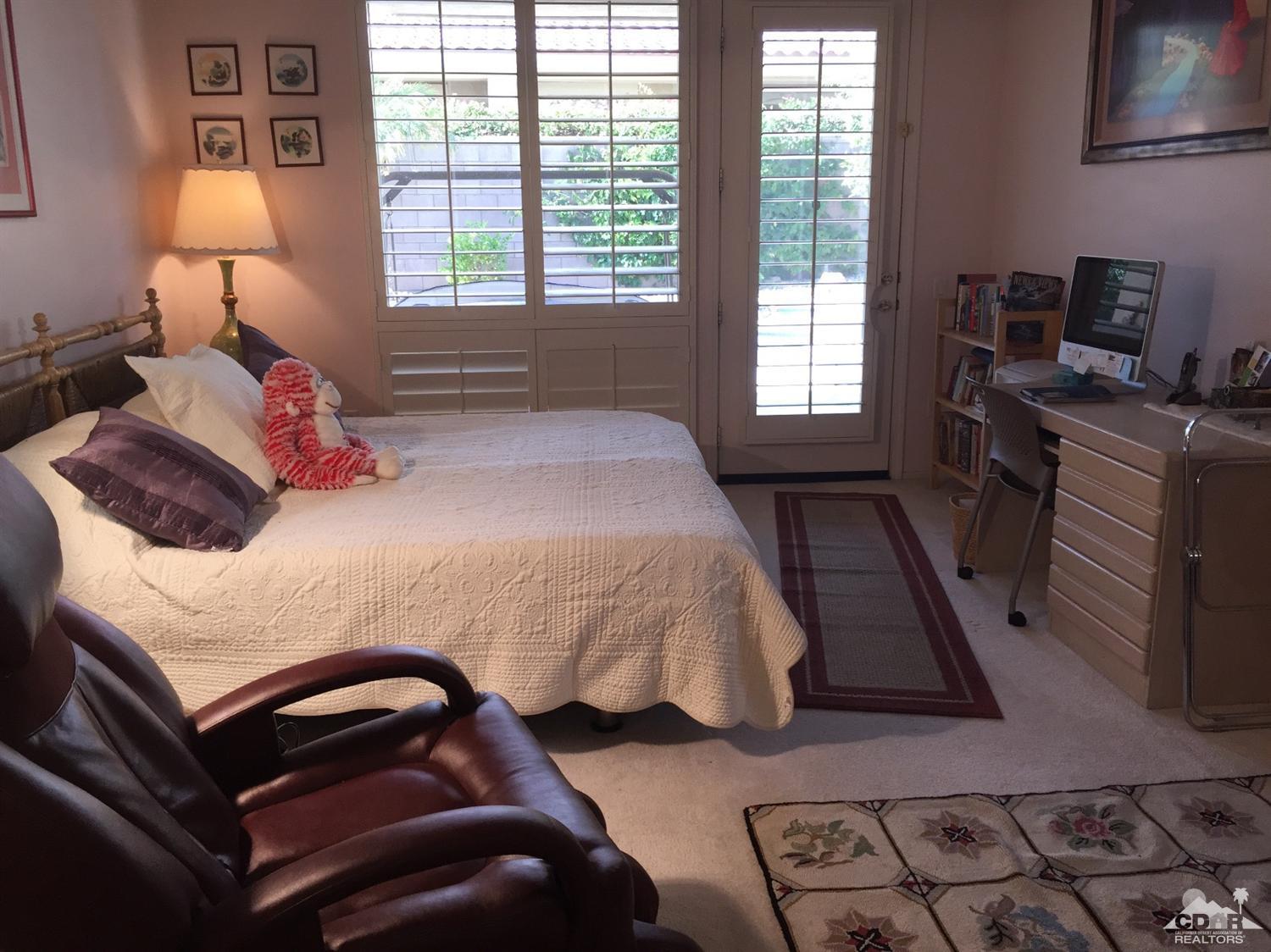 37339 Skycrest Road Palm Desert, CA 92211 - Photo 26 of 39 a bedroom with a bed and a lamp on dresser