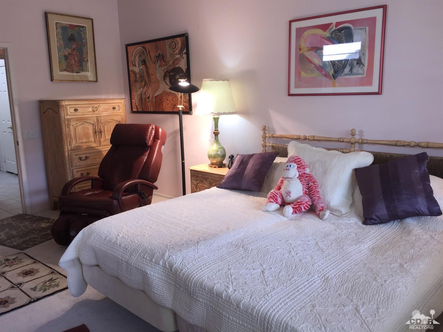 37339 Skycrest Road Palm Desert, CA 92211 - Photo 27 of 39 a bedroom with a bed and wall painting