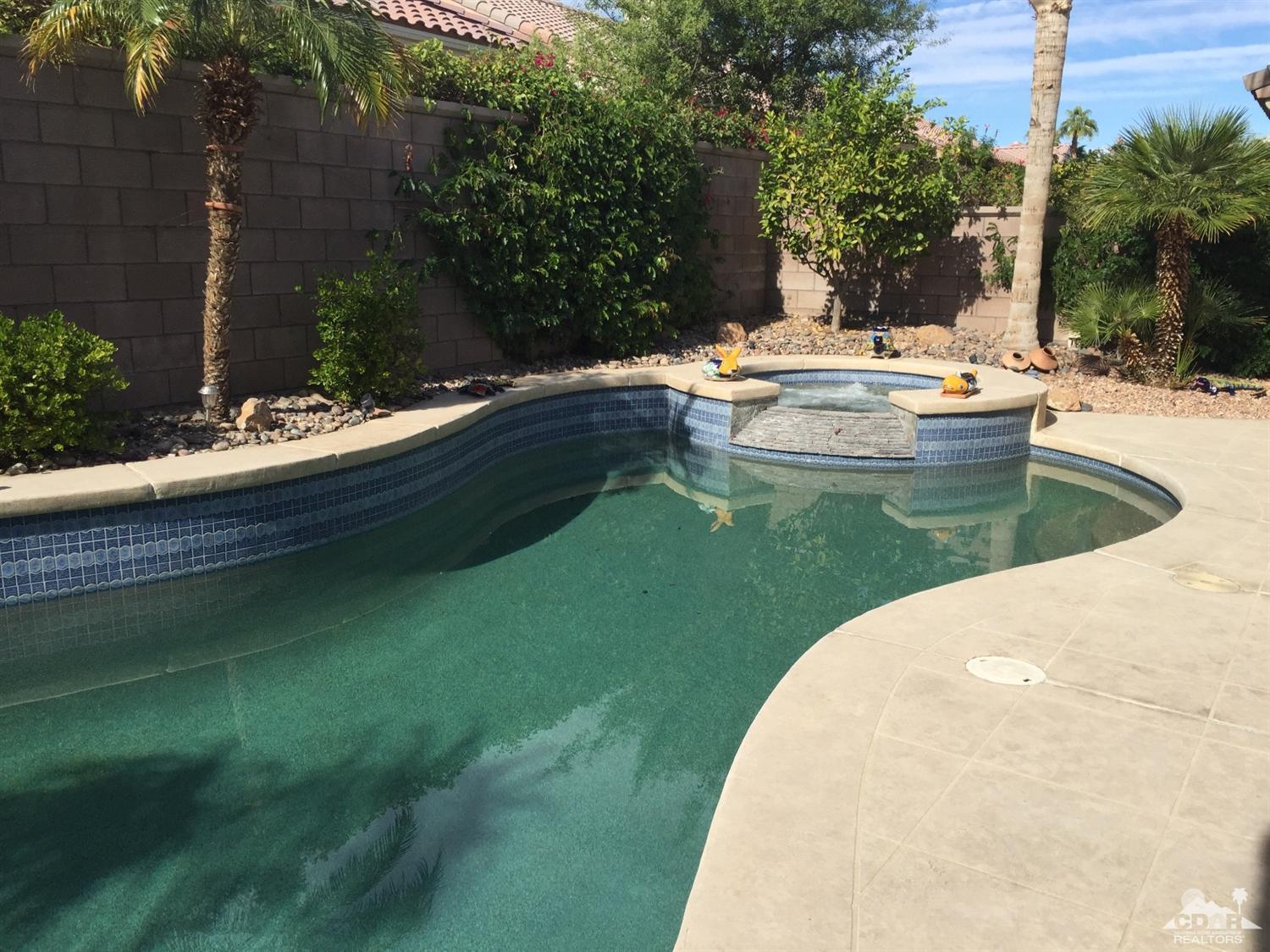 37339 Skycrest Road Palm Desert, CA 92211 - Photo 30 of 39 a view of a swimming pool with a garden