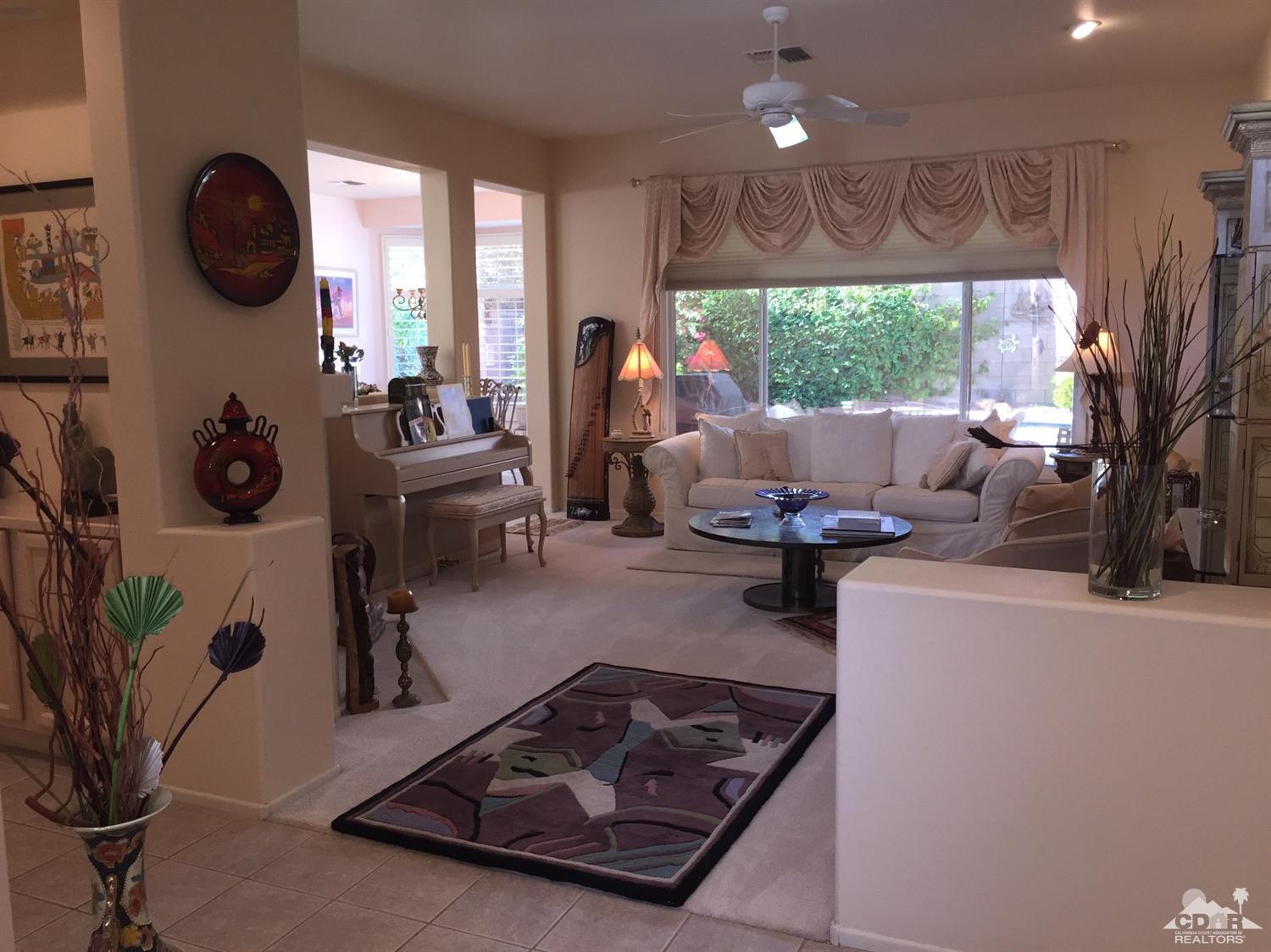 37339 Skycrest Road Palm Desert, CA 92211 - Photo 9 of 39 a living room with furniture and a large window